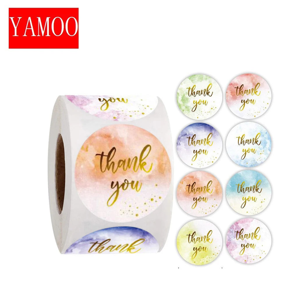A roll of watercolor thank you stickers featuring various shades of pink, yellow, and blue.