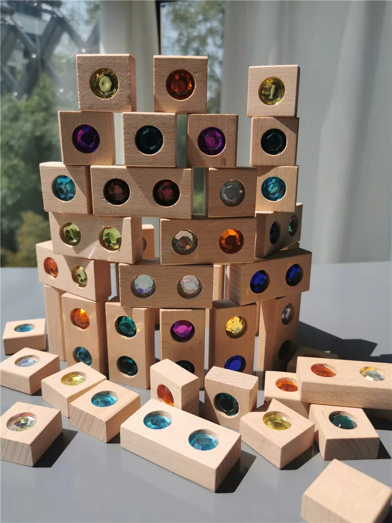 A tower of wooden gemstone building blocks featuring various colored acrylic crystals.