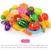 A colorful pretend play cutting set featuring various fruits and vegetables like banana, apple, grape, and tomato on a cuttin