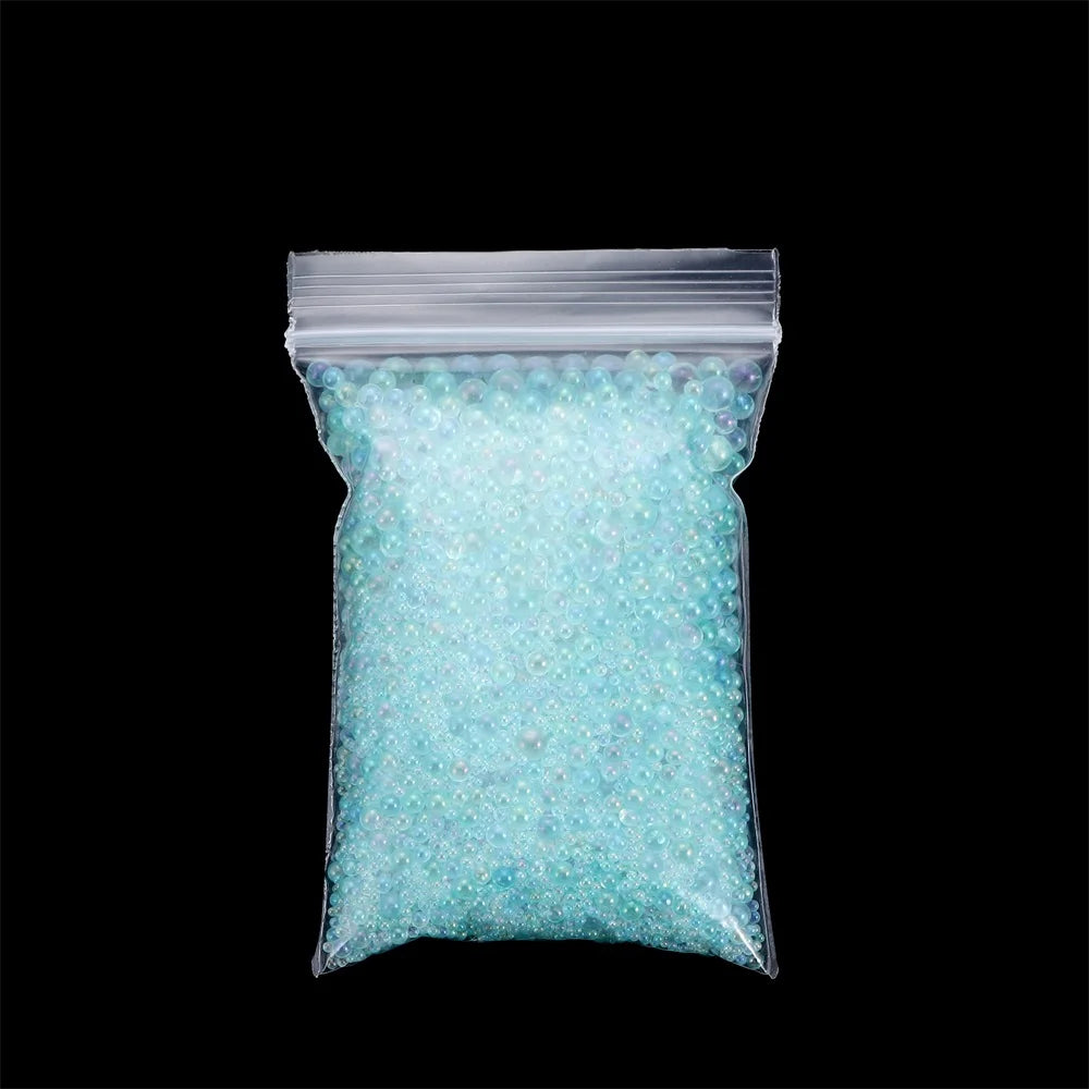 A clear plastic bag filled with light blue iridescent glass bubble beads for crafting.