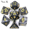 A set of black marble effect polyhedral dice including a d12, d10, d8, d6, and d1 set.
