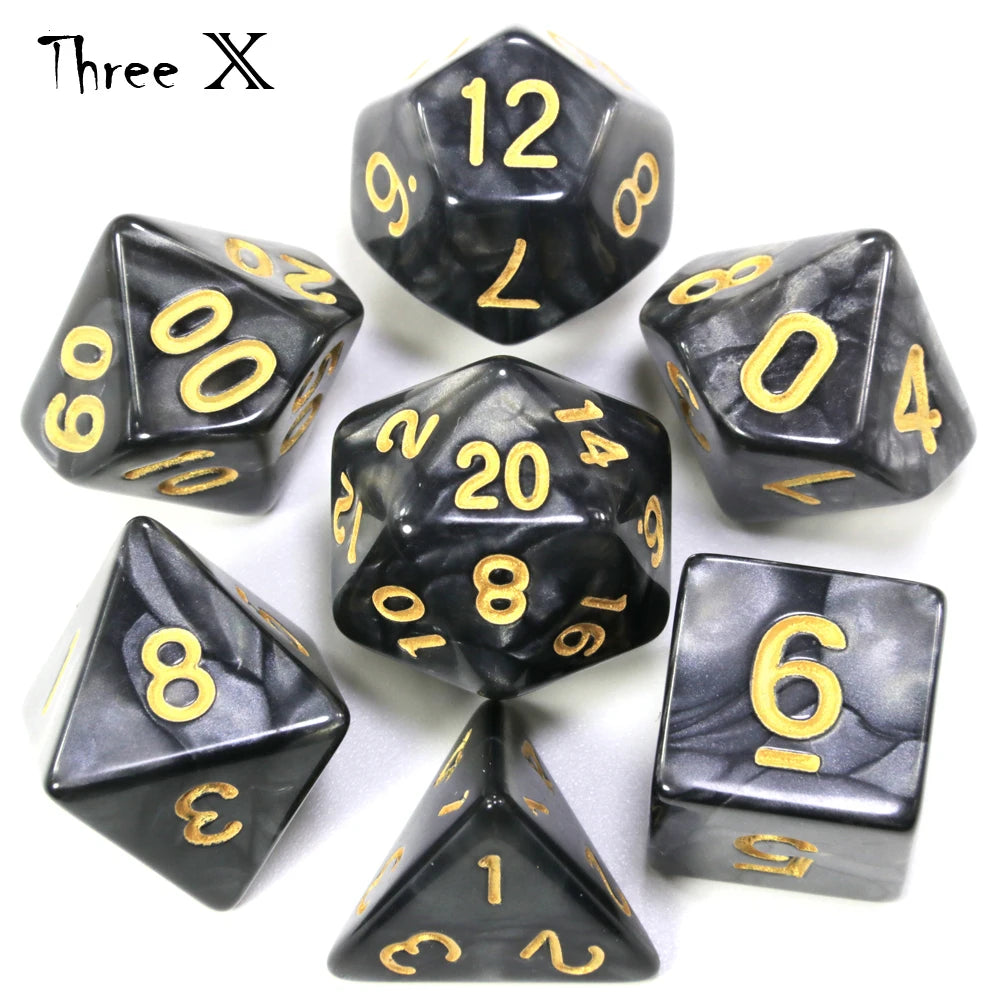 A set of black marble effect polyhedral dice including a d12, d10, d8, d6, and d1 set.
