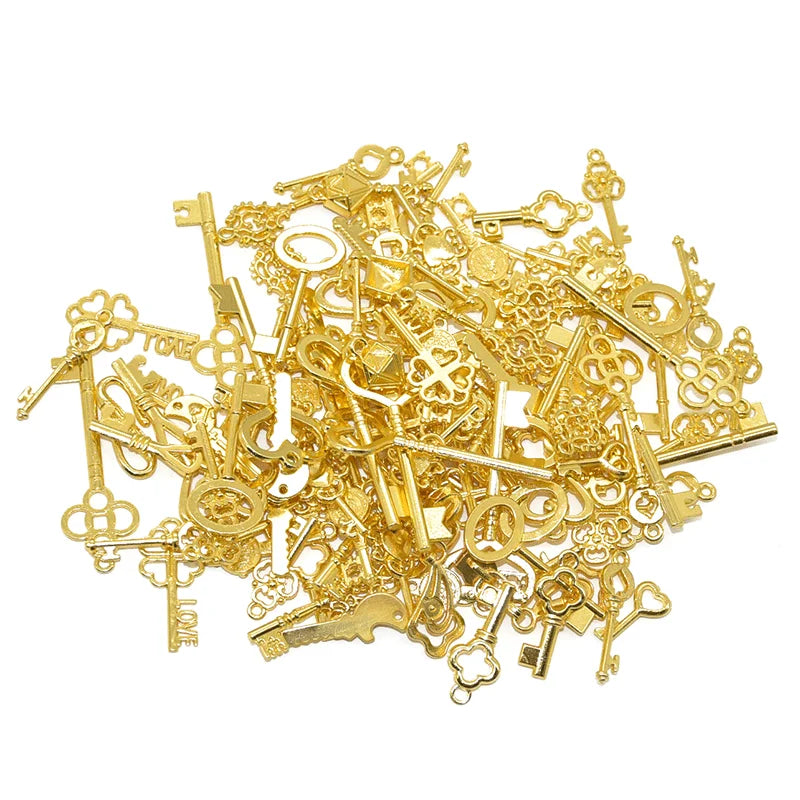 A pile of vintage gold metal key charms for DIY jewelry making