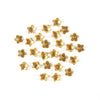 A collection of small, gold-colored Tibetan style hollow flower bead caps for jewelry making.
