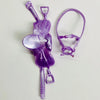A purple 1/12 scale dollhouse horse saddle and riding prop accessory.