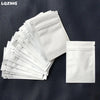 A stack of white mini reusable ziplock bags is displayed on a dark surface.