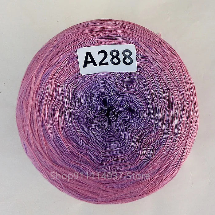 A spool of purple and pink rainbow gradient mercerized cotton cake yarn labeled A288