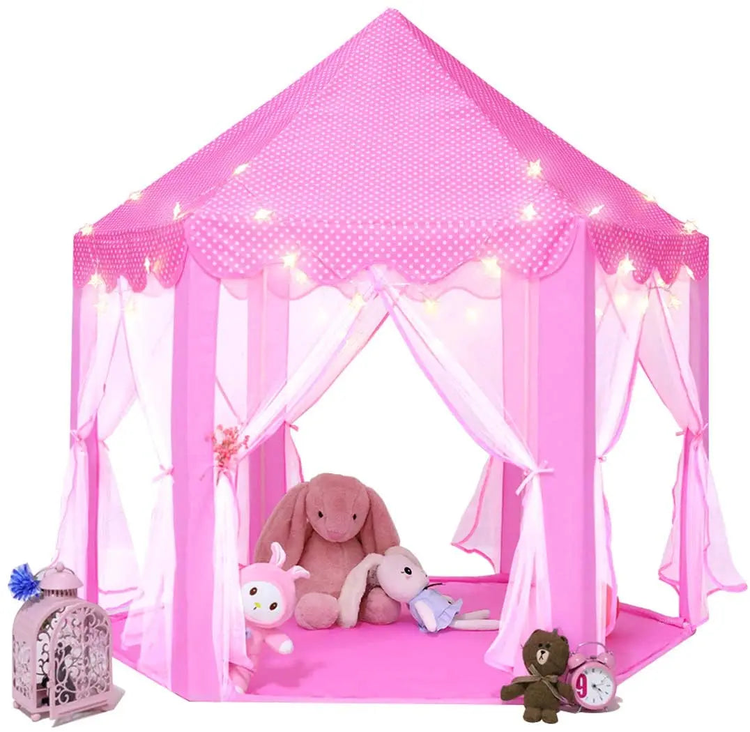 A pink kids castle play tent with lights and a stuffed animal inside.