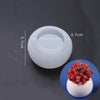 A clear silicone mold with a diameter of 8.7cm and a height of 5.7cm shown next to a finished red flower-shaped object.