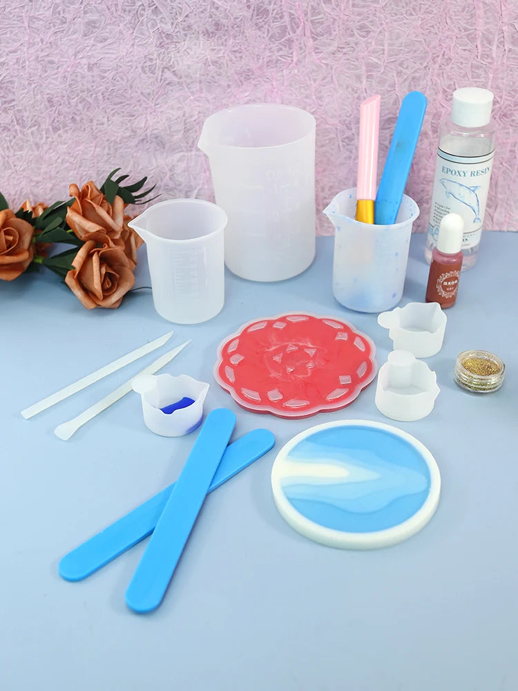 A collection of reusable silicone stir sticks, mixing tools, and resin components for crafting.