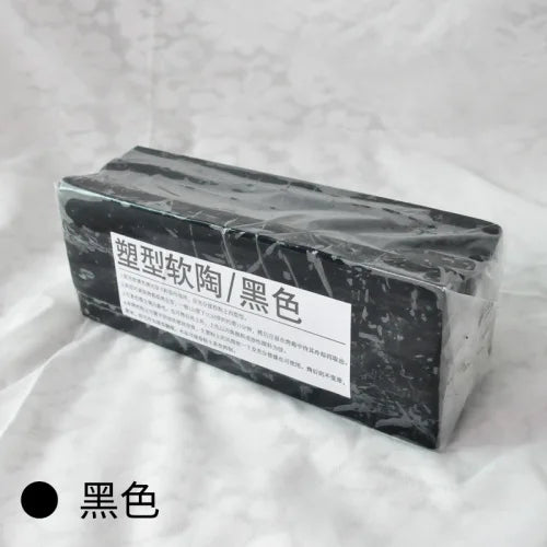 A rectangular block of black professional soft polymer clay for sculpting and doll making