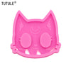 A pink silicone mold shaped like a cat's head for DIY keychains and craft projects.