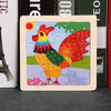 A wooden tangram puzzle featuring a colorful bird design with red and orange feathers against a green background.