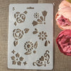 A white silicone stencil with various floral and vine designs for crafting and wall art.