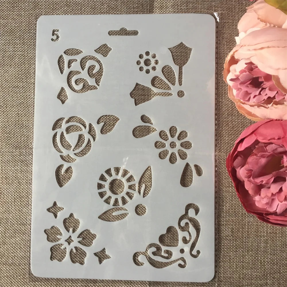 A white silicone stencil with various floral and vine designs for crafting and wall art.