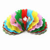 A colorful display of magical trick bags made of paper in red, green, yellow, and pink.