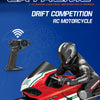 A black and red RC motorcycle is shown in a racing stance with a rider, next to a remote control transmitter.