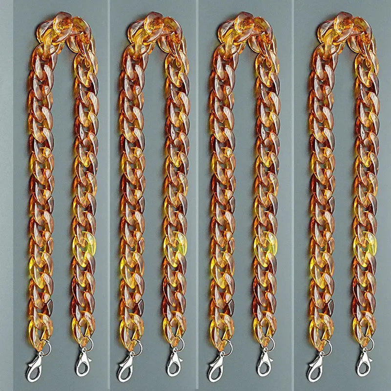 Four strands of amber acrylic bag chain straps with metal clips displayed vertically.