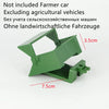 A green plastic tractor attachment for a remote control vehicle, showing various sized parts.