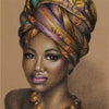 A portrait of a beautiful Black woman wearing a patterned headwrap and gold necklace.