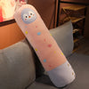 A long, light pink stuffed animal plush pillow shaped like a penguin with colorful confetti dots.