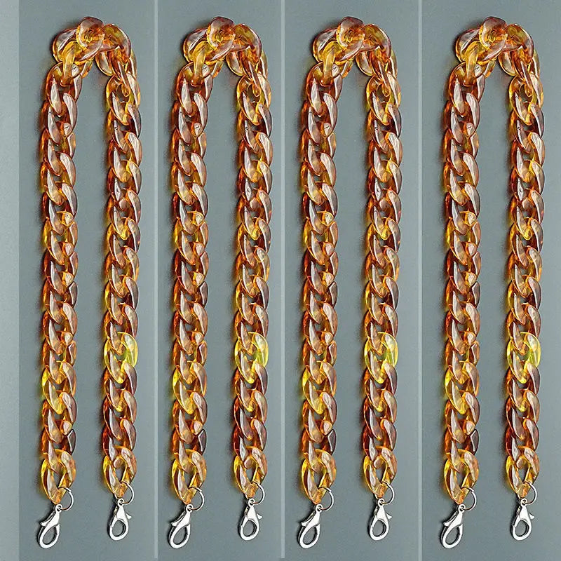 Four strands of amber acrylic bag chain straps with metal clips displayed vertically.