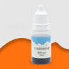 A small glass bottle of blue liquid colorant labeled for use in DIY bath and craft projects