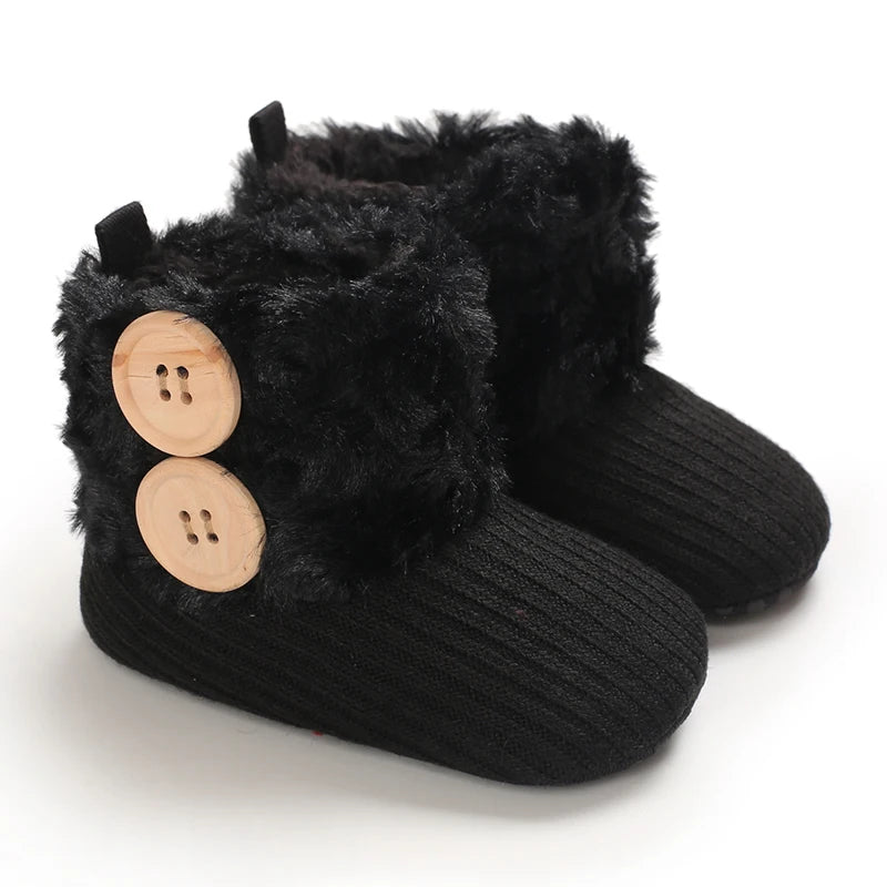 A pair of black plush baby snow boots with faux fur trim and anti-slip soles.