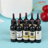 Ten miniature resin wine bottles in various colors and labels for dollhouse decor