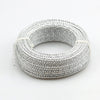 Silver flexible aluminum craft wire coiled into a circular bracelet shape for jewelry making