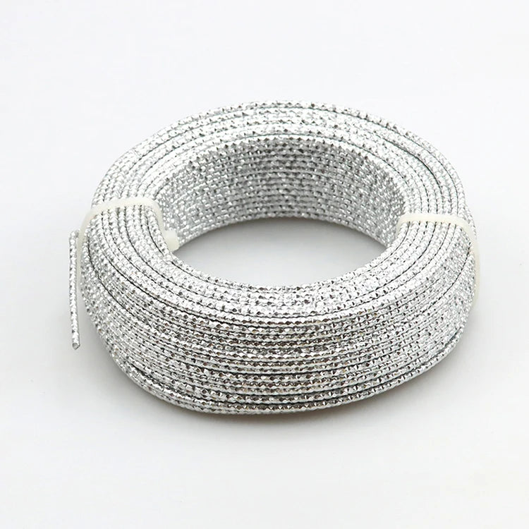 Silver flexible aluminum craft wire coiled into a circular bracelet shape for jewelry making