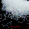 A pile of small, iridescent glass bubble beads in various shades of pink and blue.