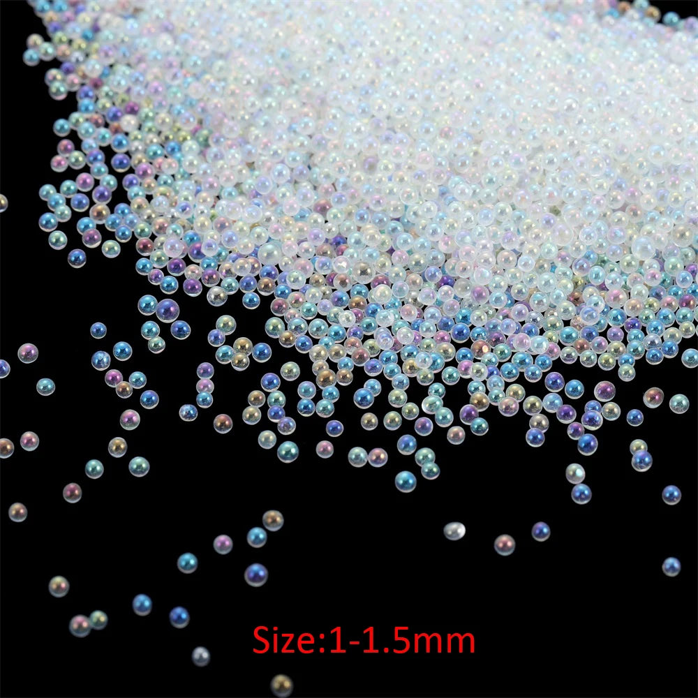 A pile of small, iridescent glass bubble beads in various shades of pink and blue.