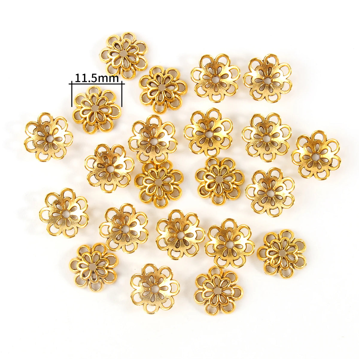 A collection of gold-colored Tibetan style hollow flower bead caps for jewelry making, shown with a measurement tool.