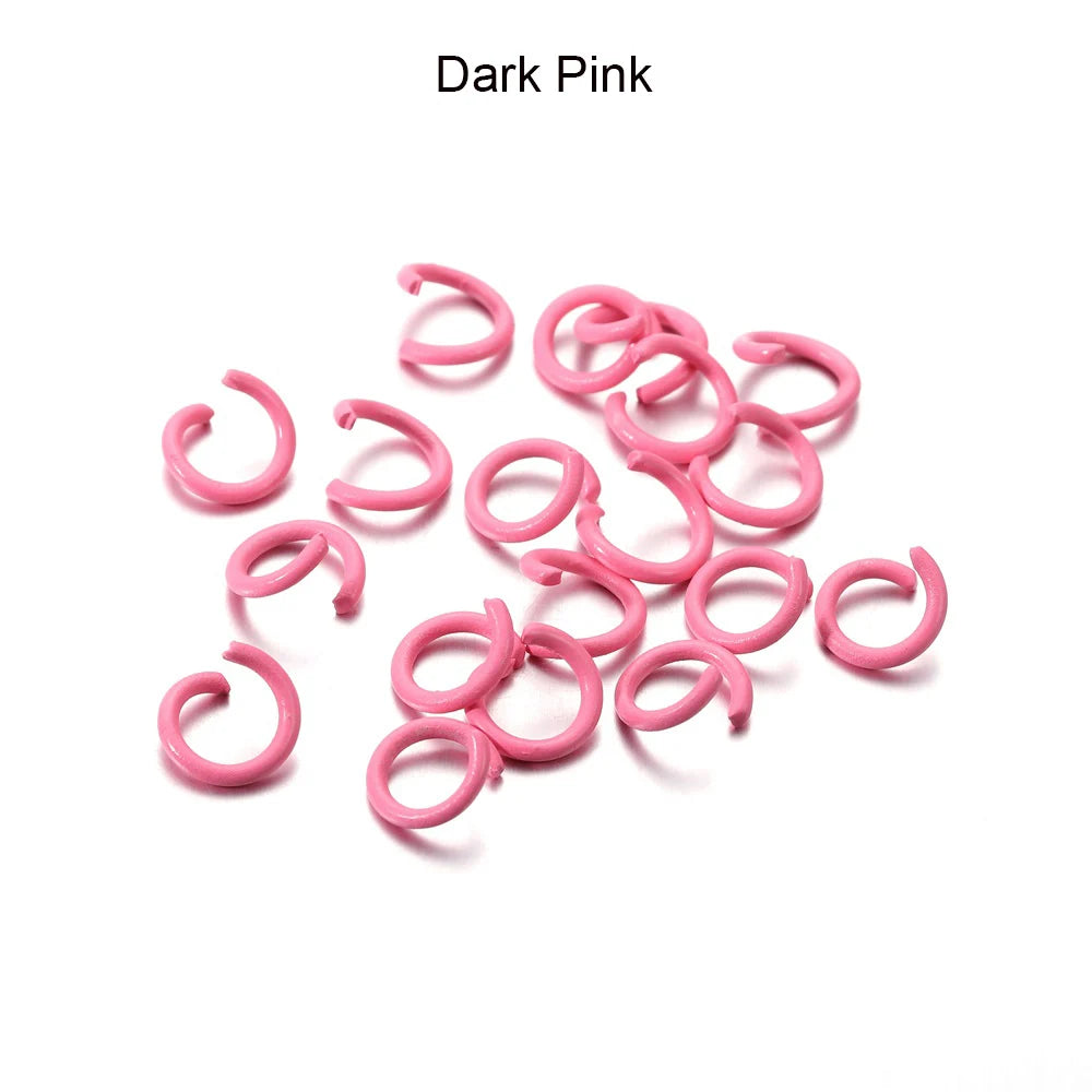 A pile of pink metal open jump rings for DIY jewelry making