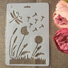 A white stencil sheet showing various floral and botanical designs for crafting projects.
