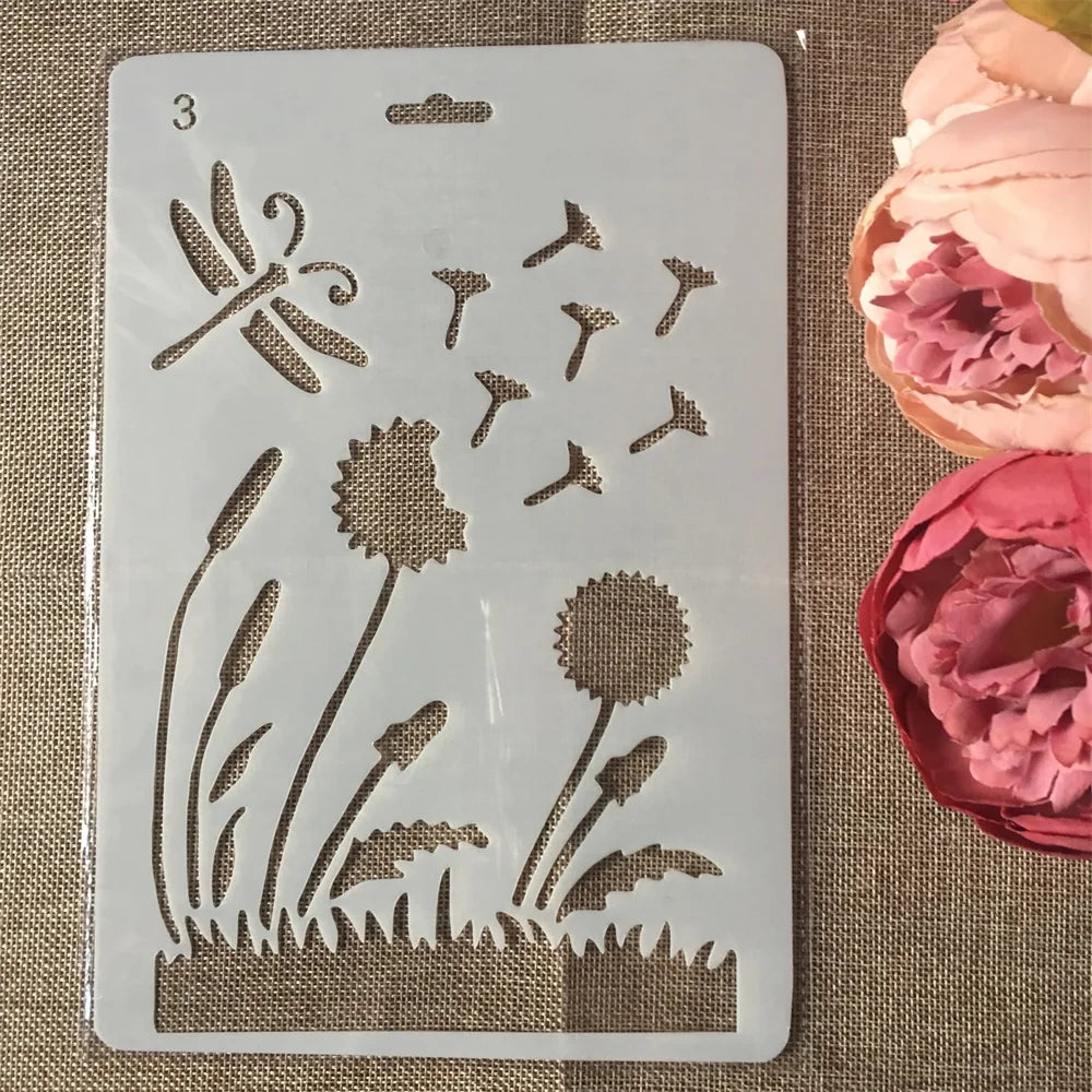 A white stencil sheet showing various floral and botanical designs for crafting projects.