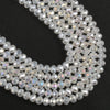 A close-up view of clear faceted crystal glass beads arranged in a curved line for jewelry making