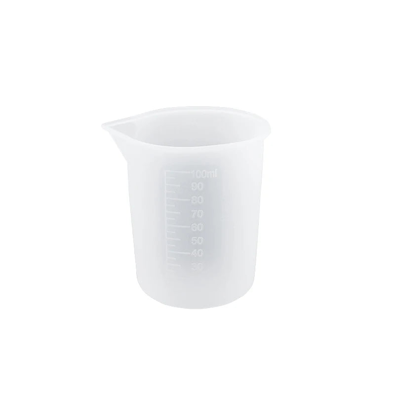 A clear silicone resin mixing tool kit with measuring cups and stir sticks.