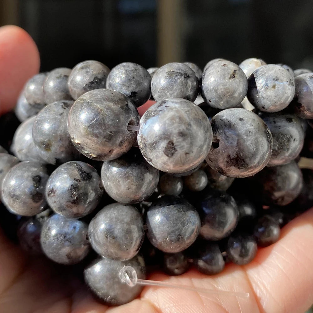 A handful of dark gray to black natural gemstone beads for jewelry making