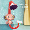 A coral red elephant bath toy featuring a sliding duck track and a colorful rainbow accessory.