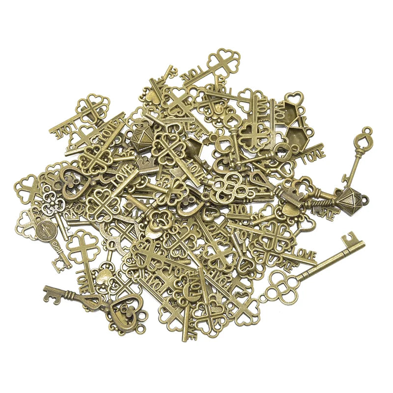 A pile of vintage brass metal key charms and skeleton keys for DIY jewelry making