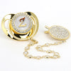 Gold and clear rhinestone pacifier featuring a Z initial on a silicone disc with a clip.