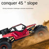 A red 4WD remote control stunt car is driving down a dirt slope, kicking up dust.
