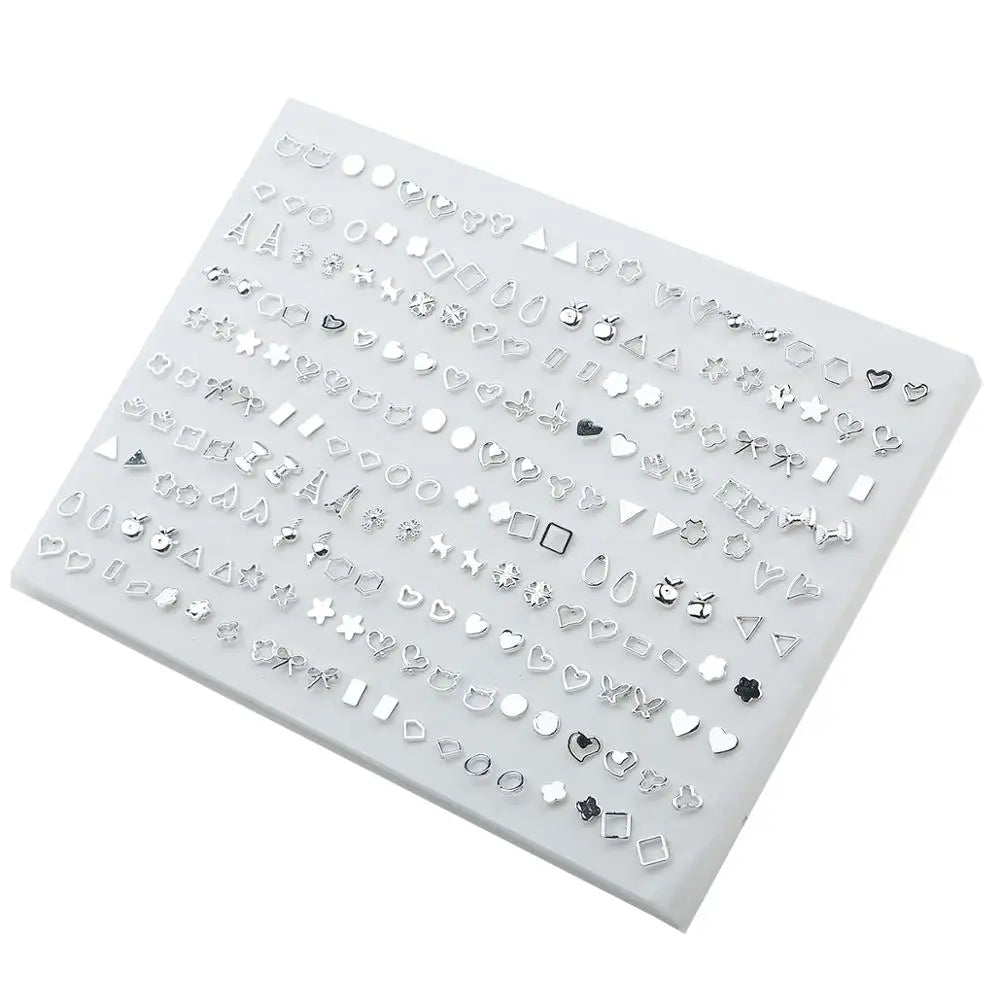 A flat display of assorted acrylic stud earrings including hearts, stars, and moons.