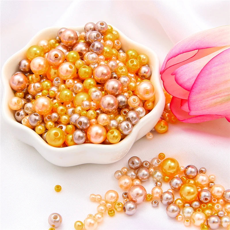 A pile of assorted golden and pinkish pearl beads for jewelry making