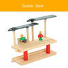 A wooden double deck train track accessory set featuring a gas station scene with two figures.