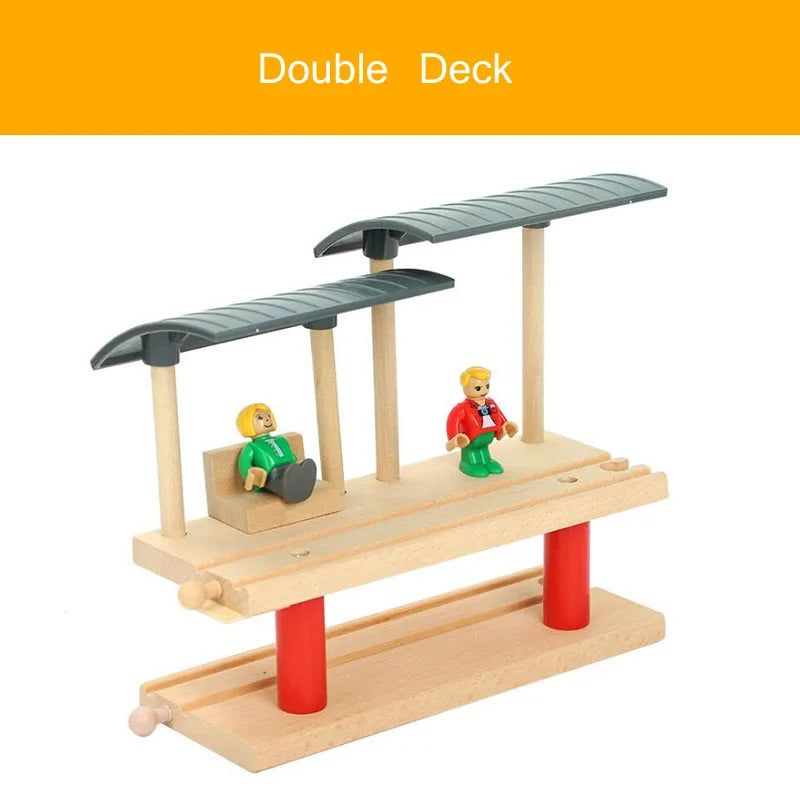 A wooden double deck train track accessory set featuring a gas station scene with two figures.