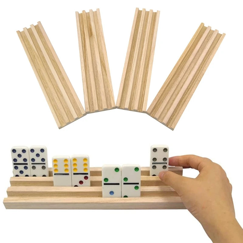 A hand holds a wooden domino rack set of four tiles used for Mexican Train and Chickenfoot games.