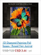 A close-up of a vibrant orange and yellow flower painted with sparkling rhinestones on a canvas.